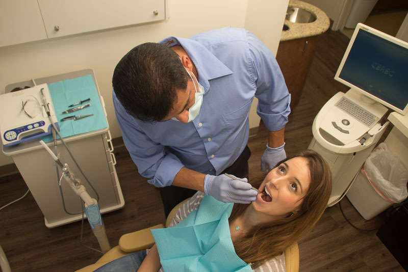 Dentist examines a patient's teeth